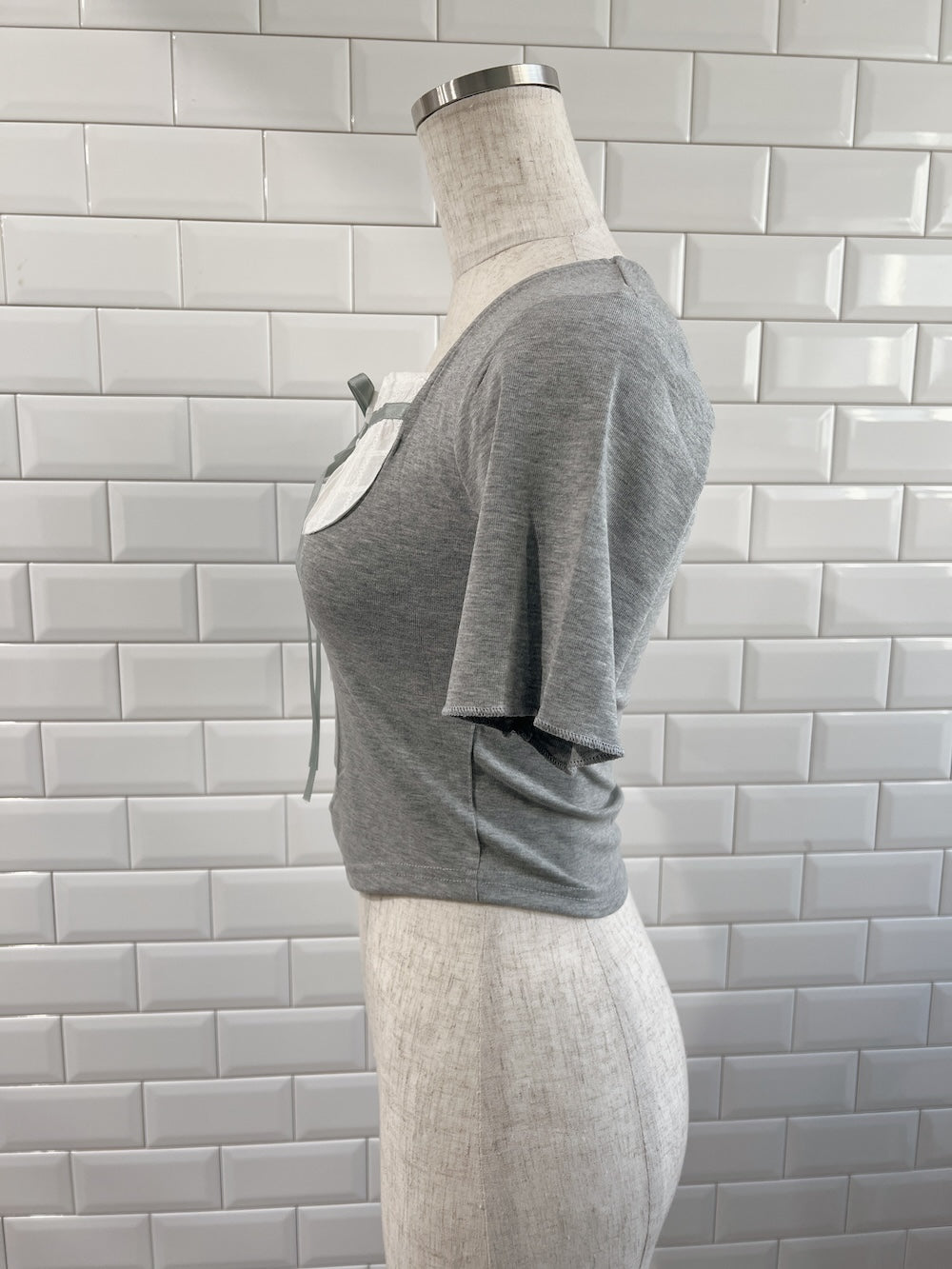 <SL2252617> ドッキングリボンネックトップス